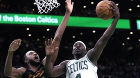 Boston Celtics guard Jrue Holiday, right, drives to the basket against Cleveland Cavaliers forward Evan Mobley during the second half of Game 1 of an NBA basketball second-round playoff series Tuesday, May 7, 2024, in Boston. (AP Photo/Charles Krupa)