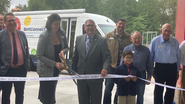 Bettendorf Public Library Director Jillian Aschliman cuts the ribbon (with Mayor Bob Gallagher) on the library's new outreach vehicle, Wednesday, Sept. 30, 2026.