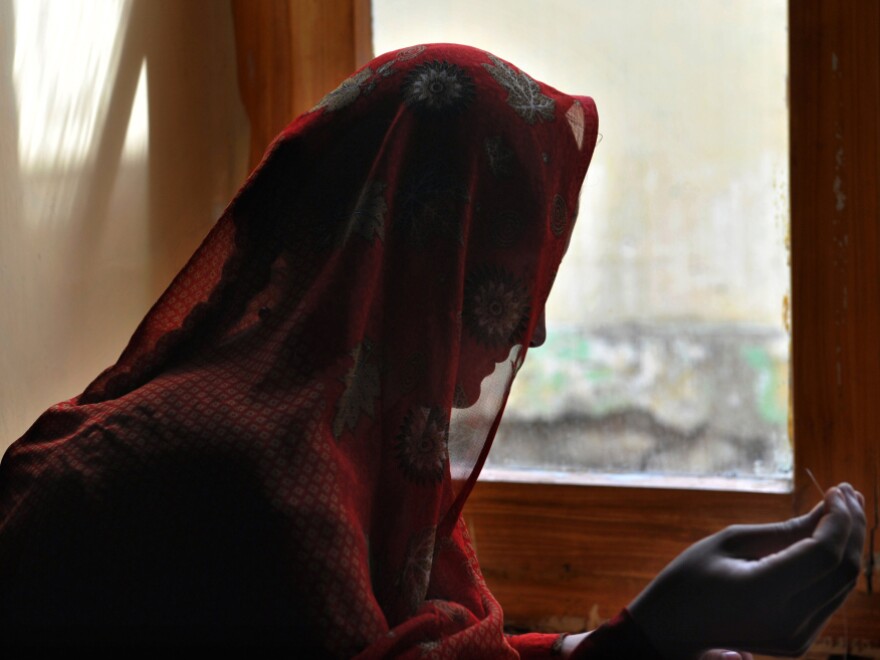 An Afghan woman makes handcrafts last October at a shelter run by women, for women. So-called honor killings are common in deeply conservative Afghanistan, along with other punishments for women suspected of contact with men outside their family.