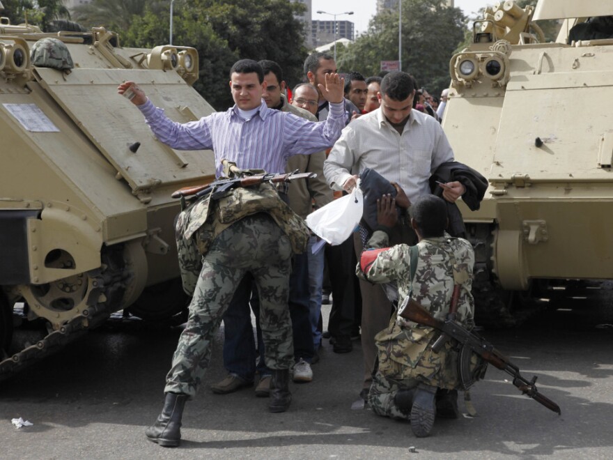 Soldiers search anti-government protesters heading to Friday rallies in Tahrir Square in downtown Cairo.