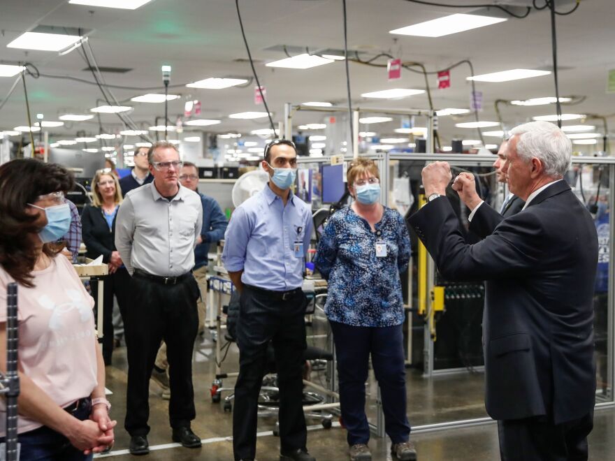 Pence talks with employees as he tours a GE ventilator plant in Madison, Wis.