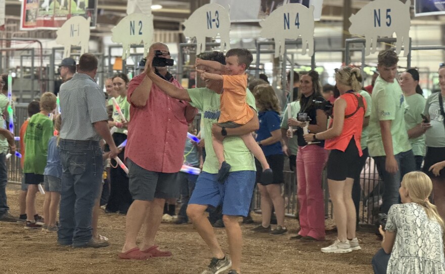 Multiple participants in the 2025 Breaking Boundaries pig show walked pigs around the indoor arena with mentors from all over Ohio