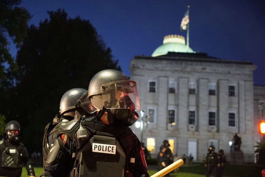 Police in riot gear protect the old state capitol building in Raleigh, N.C., on Sunday, May 31, 2020. It was the second day of protests in the North Carolina capital following the death of Minnesotan George Floyd while in police custody.