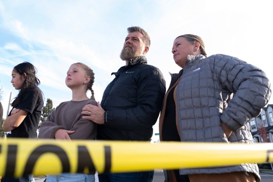 Poppy Day, 10, visits a makeshift memorial outside Silver Rail Elementary School with her parents Brian and Stephanie Day on Oct. 17, 2026, in Bend, Ore.