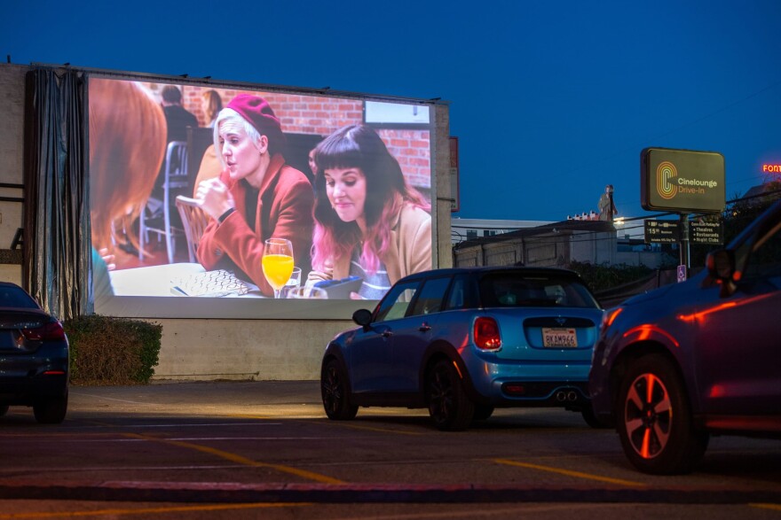 Moviegoers attend the screening of "Love, Weddings and Other Disasters" during the opening night of the first Drive-In in the Heart of Hollywood For The Awards Season organized by Arena Cinelounge Sunset at The Egyptian Theater, Dec. 4, 2020, in Hollywood, California. (Valerie Macon/AFP via Getty Images)