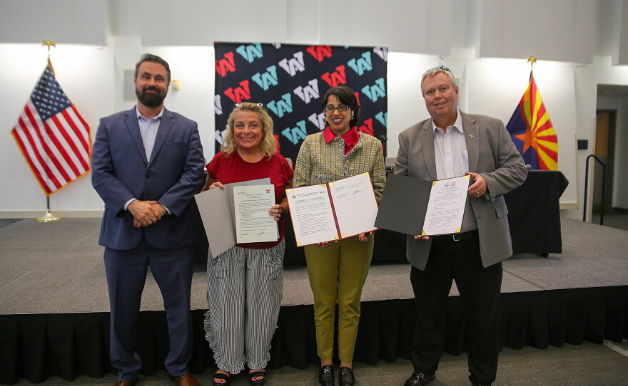 Arizona Western College leadership hold up the memoranda of understanding agreements. From left to right: Dr. Shadi Kilani, executive vice president of AWC's Entrepreneurial College; Renee Macaluso, dean of mathematics, science and engineering at AWC; Dr. Reetika Dhawan, AWC president; and Bryan Doak, executive vice president of learning and student services.