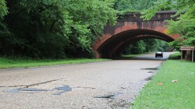 One of the high-traffic stretches of the Colonial Parkway has several spots where potholes have been temporarily patched and concrete slabs are sinking. (Photo by Ryan Murphy)