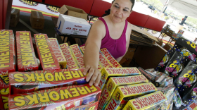 Dominique Tafoya arranges some of the new fireworks stock at a local fireworks concession stand, July 1, 2011, in Phoenix. Extremely hot, dry conditions forecast through the Fourth of July across much of the West are heightening concerns about wildfires and the dangers of fireworks.