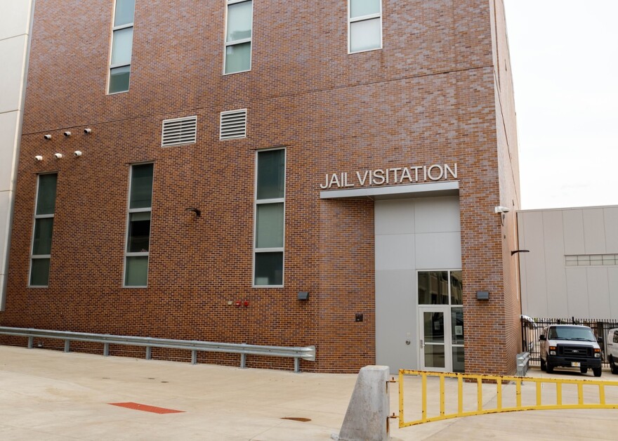 Brick building with sign reading 'Jail Visitation' above the entrance