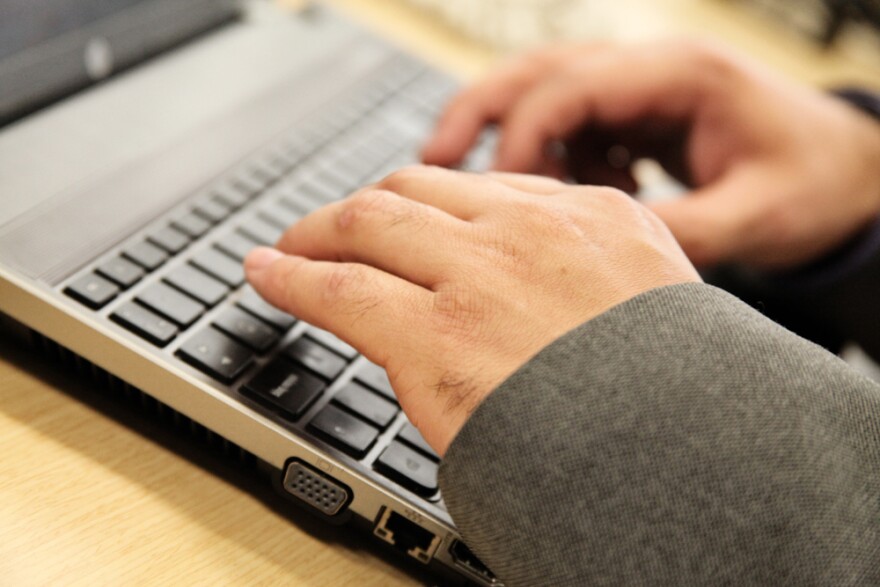 Image of hands typing on laptop