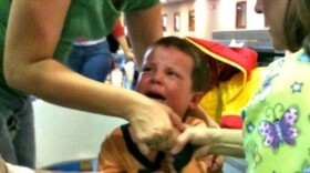 A Tulsa tot gets his shot at an earlier vaccination clinic in Tulsa.
