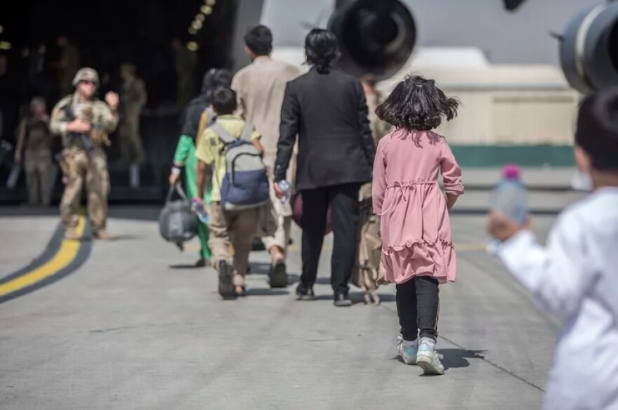 Families board a U.S. Air Force Boeing C-17 Globemaster III during an evacuation at Hamid Karzai International Airport in Kabul, Afghanistan in October 2021.