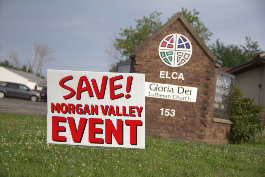 A sign reading "Save Morgan Valley Event" is shown in the grass. 