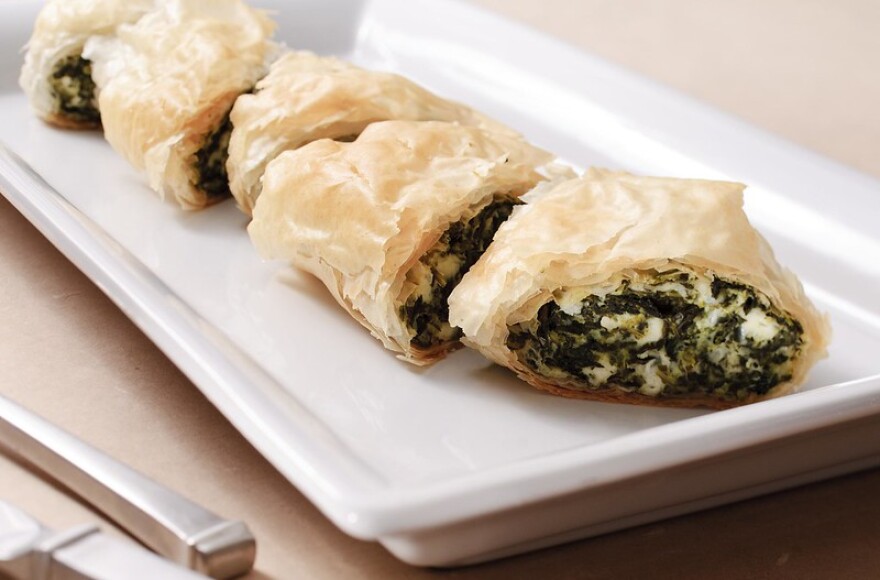 Spanakopita (spinach pies) on a white plate