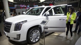 Visitors look at a Cadillac Escalade at the China Auto Show in Beijing in 2018. For General Motors, China is a bigger market than the United States.