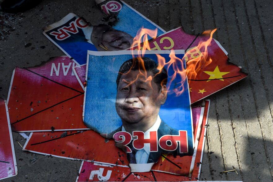 Members of National Students' Union of India (NSUI) burn a poster of Chinese President Xi Jinping during an anti-China demonstration in Ahmedabad on June 18, 2020. - India and China agreed on June 17 to ease tensions at their disputed Himalayan border, even as they traded blame for a brawl that left at least 20 Indian soldiers dead. (Photo by SAM PANTHAKY / AFP) (Photo by SAM PANTHAKY/AFP via Getty Images)