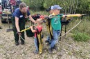 Ashley, from The Nature Conservancy, shows the Jacob, Graham and Jeremy Githens how some of the gear is used in prescribed burns.