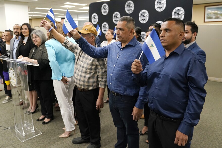 Nicaraguan political prisoners released on Feb. 9 and flown to the U.S. hold Nicaraguan flags during a press conference at Miami-Dade County Mayor Daniella Levine-Cava's office last month.