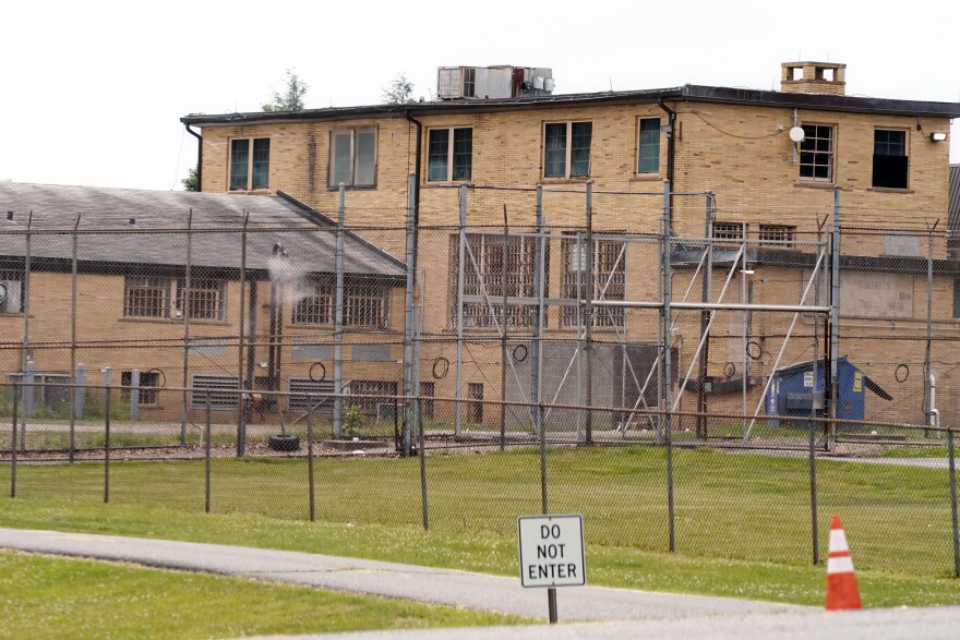 FILE - A high fence surrounds buildings on the grounds of the Edna Mahan Correctional Facility for Women in Clinton, N.J., June 8, 2021. New Jersey Gov. Phil Murphy said Wednesday, Nov. 1, 2023, that his administration has shuttered part of the state's only women's prison, partially fulfilling a promise made more than two years ago to close the facility amid reports of sexual abuse and misconduct there. (AP Photo/Seth Wenig, File)