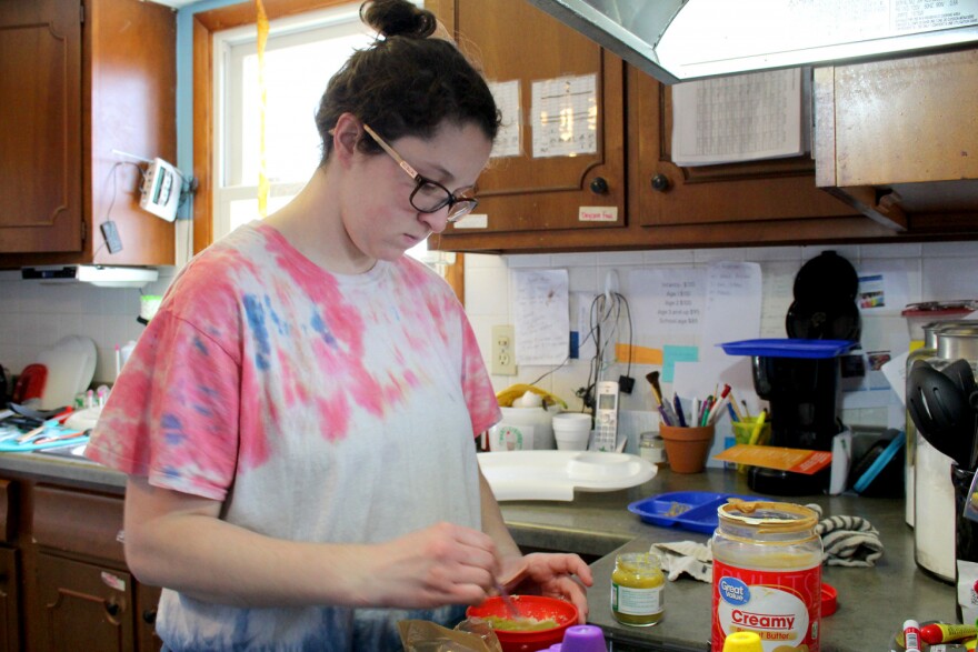 Trinaty Carr prepares oatmeal for the infant during snack time at her licensed in-home daycare.