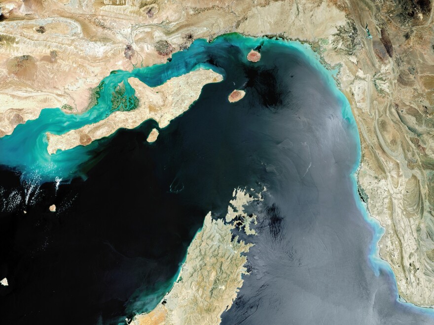 A 2017 satellite image of the Strait of Hormuz, a strategic maritime choke point with Iran situated at the top with Qeshm Island and the United Arab Emirates to the south.