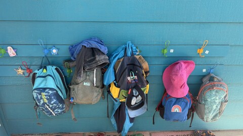 Kids’ backpacks hang outside Thompson Schoolhouse, an in-home day care run by Ali Cottle in Carbondale on July 10, 2025.