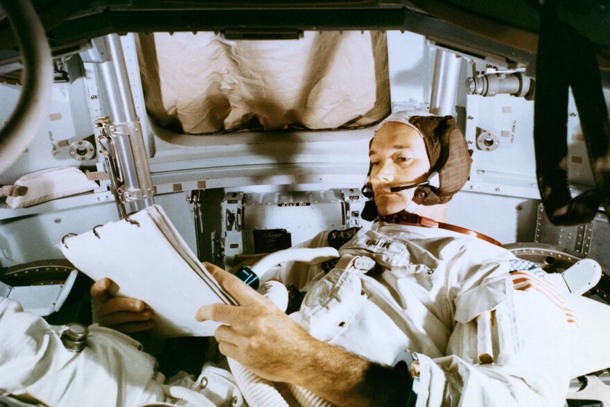 Astronaut Michael Collins, studies flight plan during simulation training at the Kennedy Space Center prior to the scheduled Apollo 11 mission.