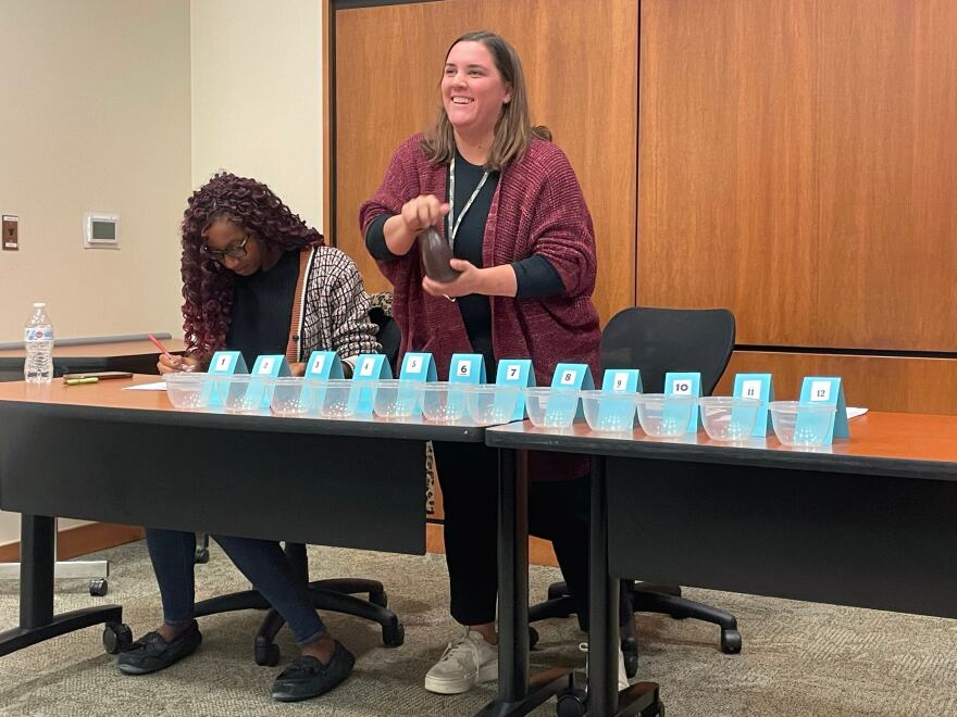 Christa Miller, Lancaster County’s election director, shakes a bottle filled with red, numbered marbles to determine the winner of tied races.