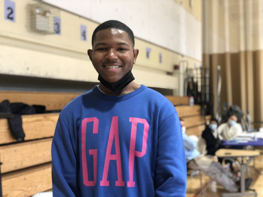 Clifford White, 16, a junior at Achievement First Amistad High School in New Haven, works at the Conte West Hills Middle School polling station on Election Day 2020.