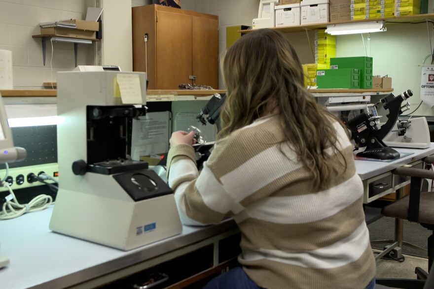 Graduate student Hannah Jordan helps make glasses in the lab on IU's campus.