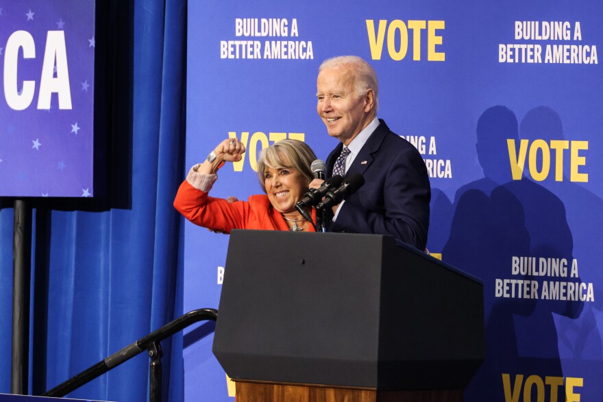 Governor Michelle Lujan Grisham (right) and President Biden (left) share a hug on stage following the conclusion of Thursday's rally