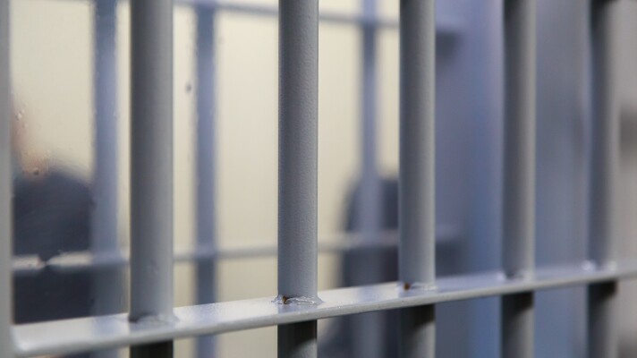 Typical modern prison bars. Symbolic illustrative background for crime news.