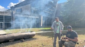 Nakai Clearwater Northup (right), head of education at the Mashantucket Pequot, carves up deer meat alongside Miguel Ortiz with visitor services. 