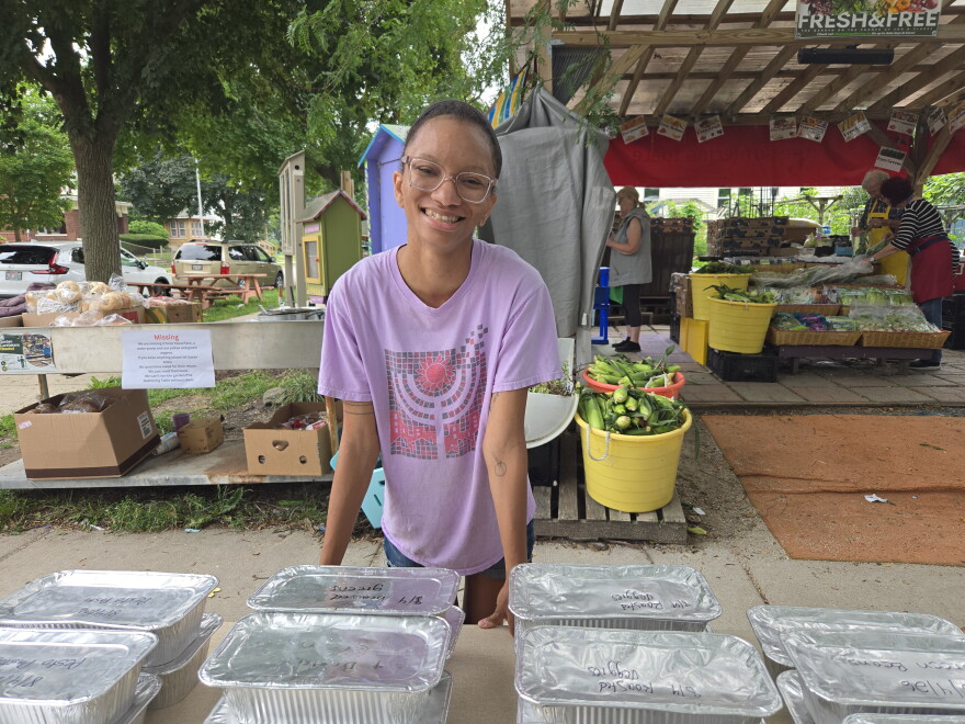Food Justice Director for Tikkun Ha Ir, Amanda McVann, hands out family-sized portions of the week's meals at the Gathering Table outside All People's Church.