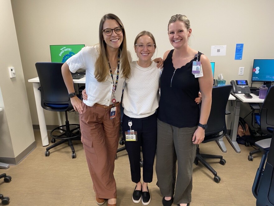Three women: Dr. Lauryn Roth, Dr. Aubrey Armento, and sports nutritionist Amanda McCarthy, smile for a photo in their clinic. They are part of the new Female Athlete Program at Children's Hospital Colorado