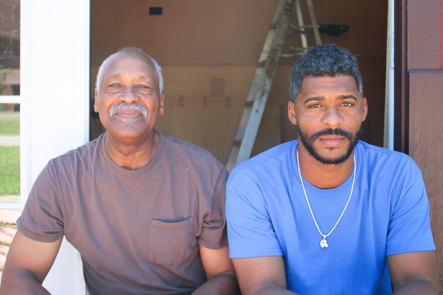 Cairo residents Lee Wright and son Roman Wright take a break from construction work earlier this summer. Both decided not to get vaccinated. "I'm like my dad," Roman Wright says. "I was born and raised in church all my life. So I say we believe in God. I know my parents pray for me. We pray for each other, and we just believe in God."