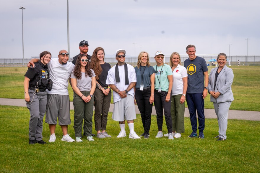 Alfredo Lolani and Alex Mendoza, members of Fit from Within, pose with state legislators and prison staff during the half-marathon.