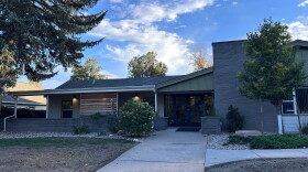 A green and grey home with the number "811" on the outside. 