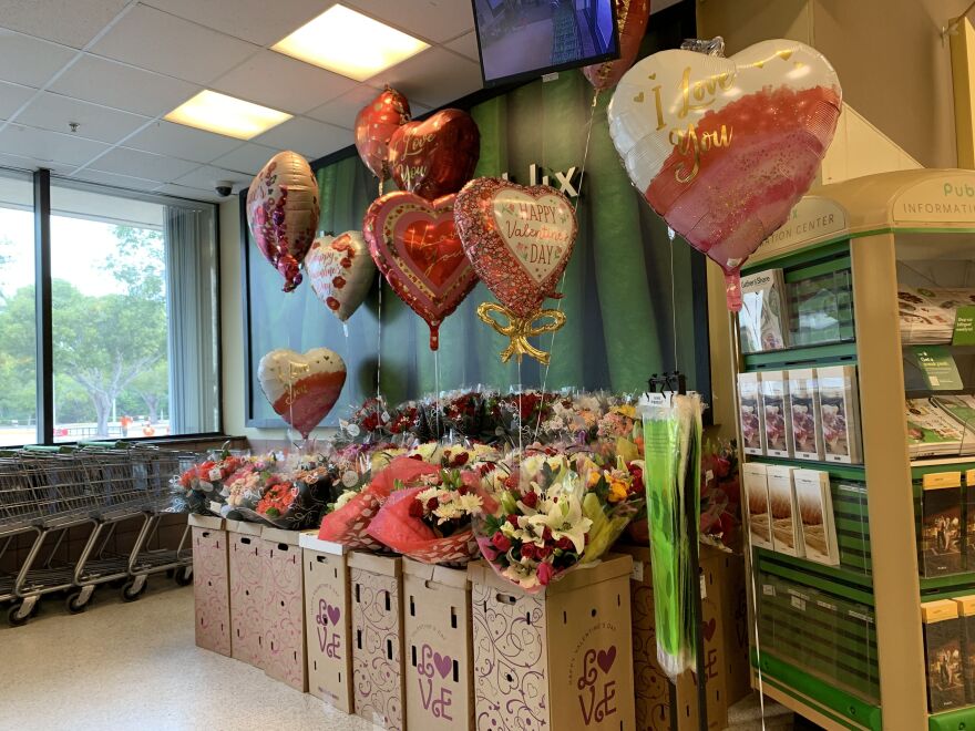 Flowers and balloons in a store display. 