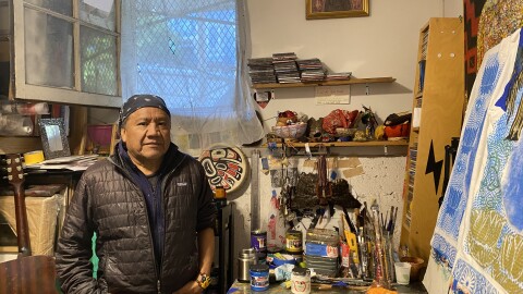 Screenprinter Calixto Robles stands in front of the light board in his studio, which he uses to cure screenprint designs into the screens. 