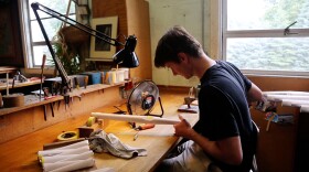 Phil Schleich works on a pipe at the Schantz Organ Company.