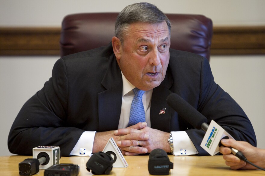 Gov. Paul LePage speaks to reporters shortly after the Maine House and Senate both voted to override his veto of the state budget, Wednesday, June 26, 2013, at the State House in Augusta, Maine. 