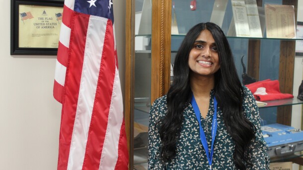 Peoria's new election commissioner Jessily Joseph stands in front of American flag