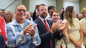 Choctaw Nation Chief Gary Batton, Homeland Security Secretary Markwayne Mullin (center) and others listen as President Donald Trump speaks at a campaign rally at the Choctaw Event Center, Thursday, Oct. 1, 2026, in Durant, Okla.