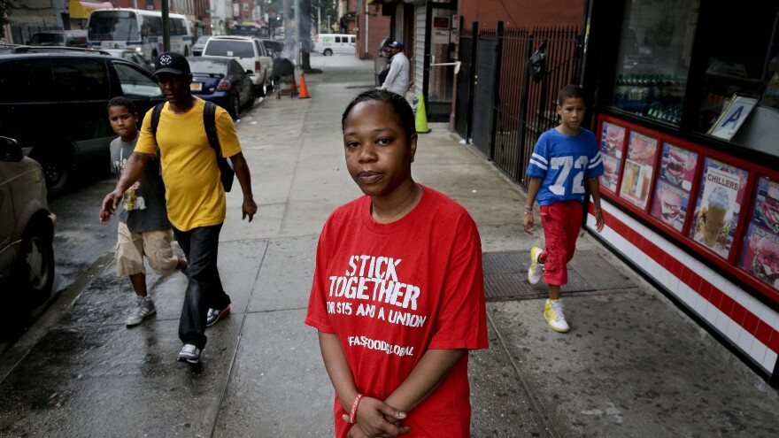 Shantel Walker stands outside a fast food restaurant June 19 in Brooklyn, New York. Walker, who made $8.25 per hour at a Brooklyn pizzeria, was part of a broad campaign by fast food workers to advocate for higher minimum wages.