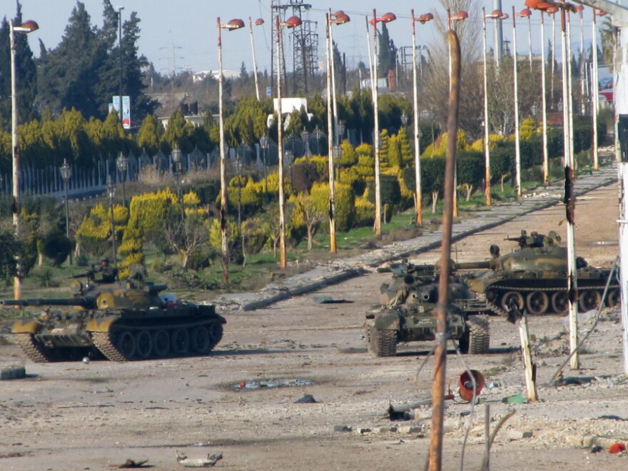Syrian army tanks are seen stationed at the entrance to Baba Amr neighbourhood in Homs on Feb. 13, 2012. Syria ignored a new Arab initiative to end the bloodshed, with its troops pounding the protest hub of Homs as Russia said a ceasefire is needed before peacekeepers can be deployed. 