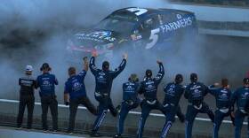 Members of Kasey Kahne's pit crew celebrate as Kahne performs a burnout following his win in the Brickyard 400 Sunday, July 23 at the Indianapolis Motor Speedway.