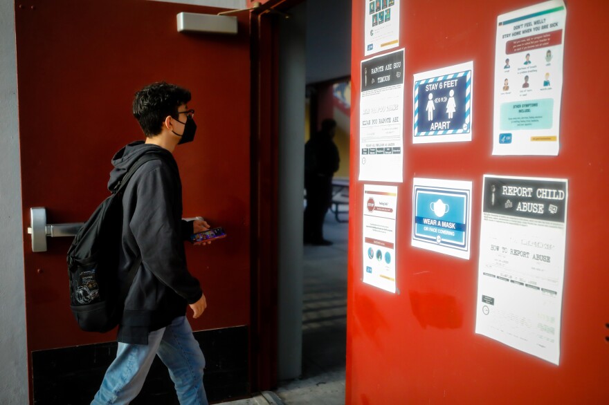 A student arrives for the first day of classes on Aug. 23 at a public school in Miami Lakes, Fla.