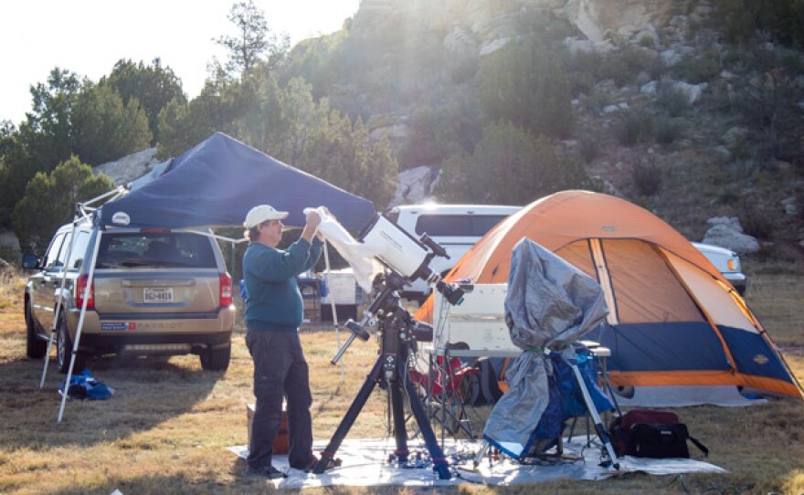 An amateur astronomer covers up his telescope shortly after sunrise at the 2016 Okie-Tex Star Party.