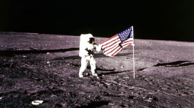 This 19 November 1969 file photo released by NASA shows Apollo 12 Astronaut Charles "Pete"  Conrad standing by the US flag on the Moon. (AFP via Getty Images)
